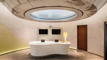 Welcome to the reception area, featuring a unique circular skylight and minimalist design.