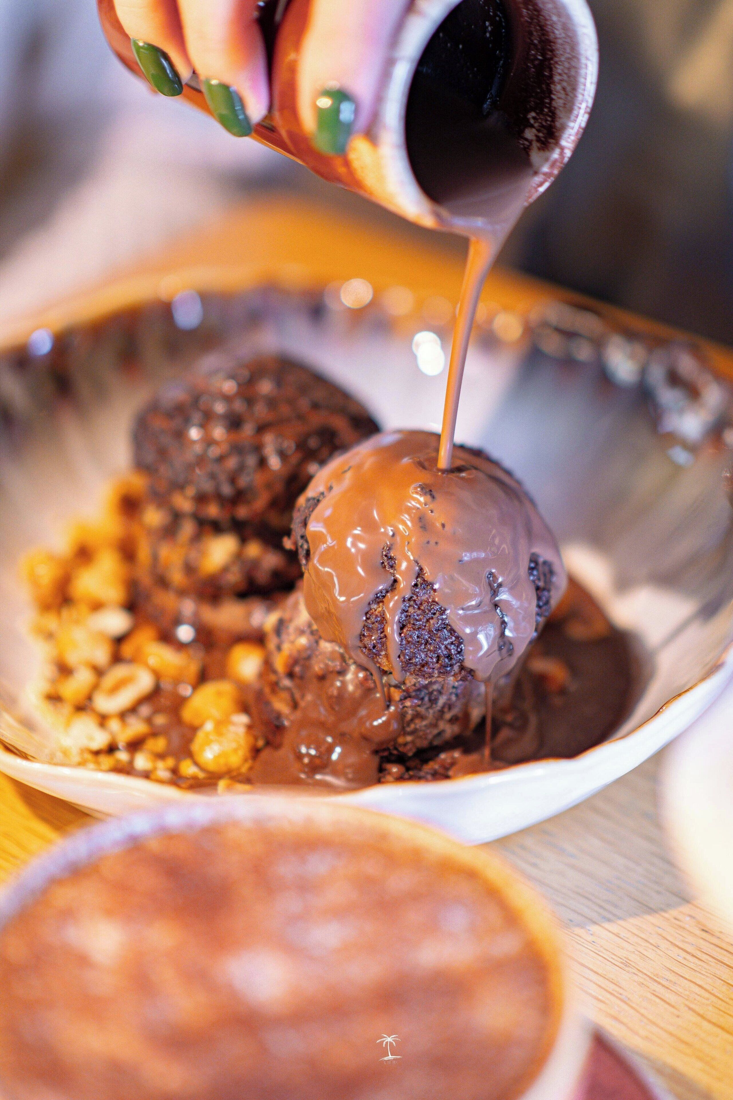 A dessert with caramel sauce being poured over it.