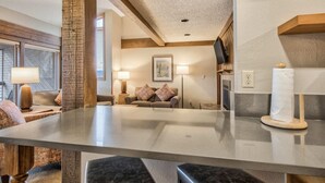 A modern living room with a glass coffee table, a sofa, and a TV mounted on the wall. - 3brbreckenridge Townhomebalcony Mtn Views Hot Tub (Breckenridge)