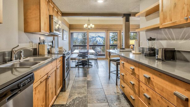A modern kitchen with wooden cabinets, stainless steel appliances, and a central island. - 3brbreckenridge Townhomebalcony Mtn Views Hot Tub (Breckenridge)