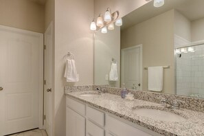 A bathroom with a granite countertop, two sinks, a large mirror, and a towel rack. - 3BR Mtn Viewsluxury Townhomecentral Locationac (Colorado Springs)