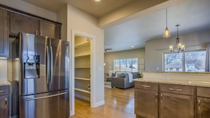 A modern kitchen with stainless steel appliances, wooden cabinets, and a built-in wine cooler. - 8BD Mnt Viewsgarden Of The Godslarge Groups (Colorado Springs)
