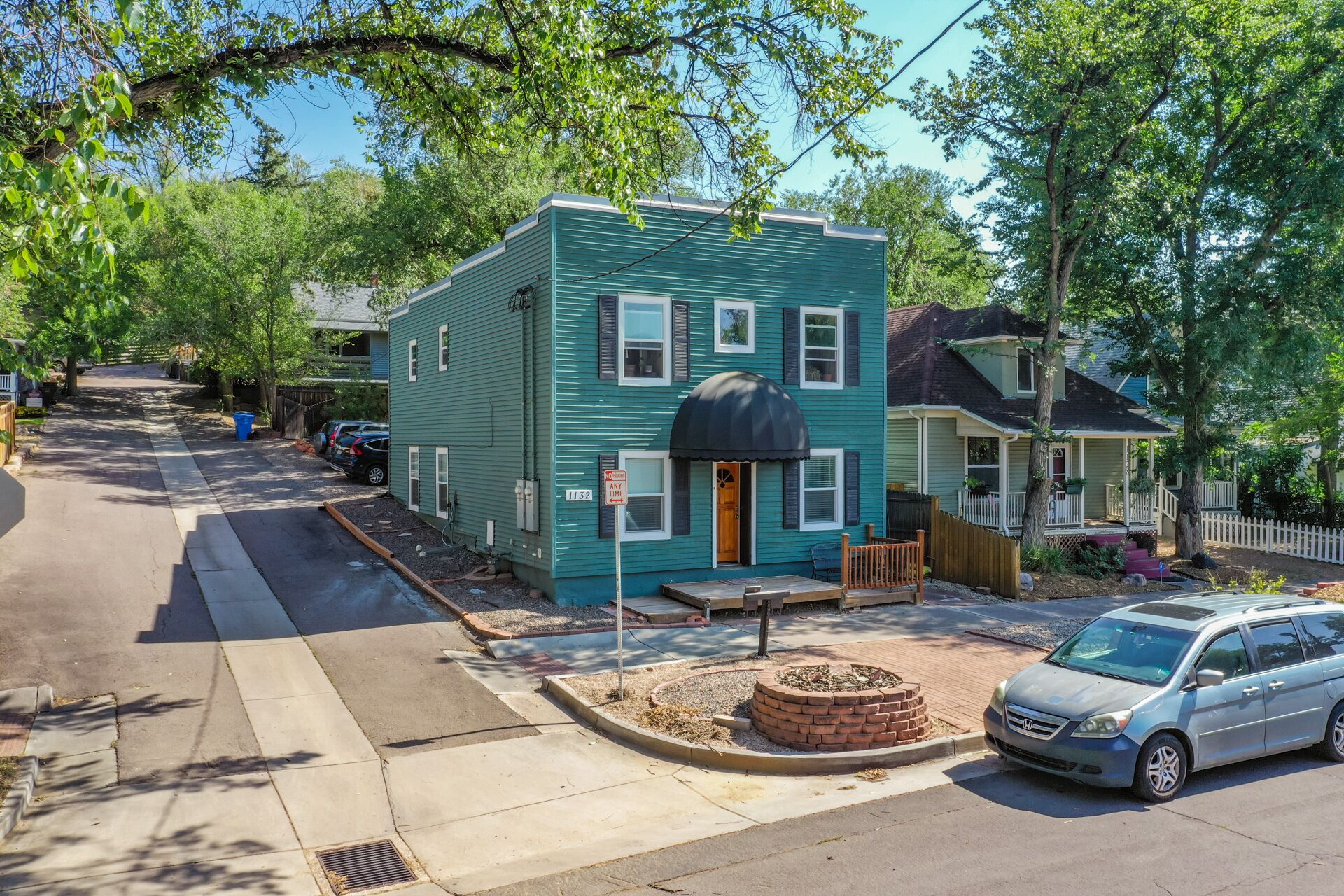 A two-story house with a front porch, a garage, and a driveway.