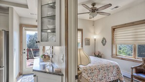 A bedroom with a bed, a ceiling fan, a window with blinds, and a view of the outdoors. - 2brdowntown Occmountain Views & Grill (Colorado Springs)