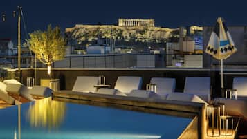 Outdoor pool, open 10:00 AM to 7:00 PM, pool umbrellas