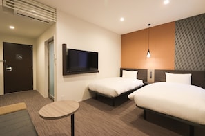 A hotel room with two beds, a TV, a small table, and a door. - Wander Kyoto Nanajo (Kyoto)