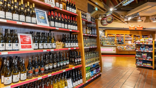 A wine store with shelves stocked with various bottles of wine. - Raststättenhotel Baden-Baden (Baden-Baden)