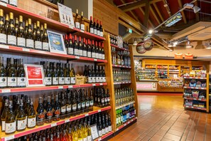 A wine store with shelves stocked with various bottles of wine. - Raststättenhotel Baden-Baden (Baden-Baden)