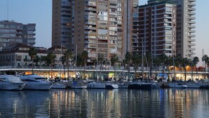 A marina with multiple yachts docked, surrounded by high-rise buildings and palm trees. - Great 2 Bedroom Apartment with wonderful views, Swimming Pool and Jacuzzi (Comares)