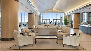A spacious lobby with a central seating area, large windows, and a reception desk. - Four Bedroom Luxury Condo with Spectacular Ocean & Bay Views (Ocean City)