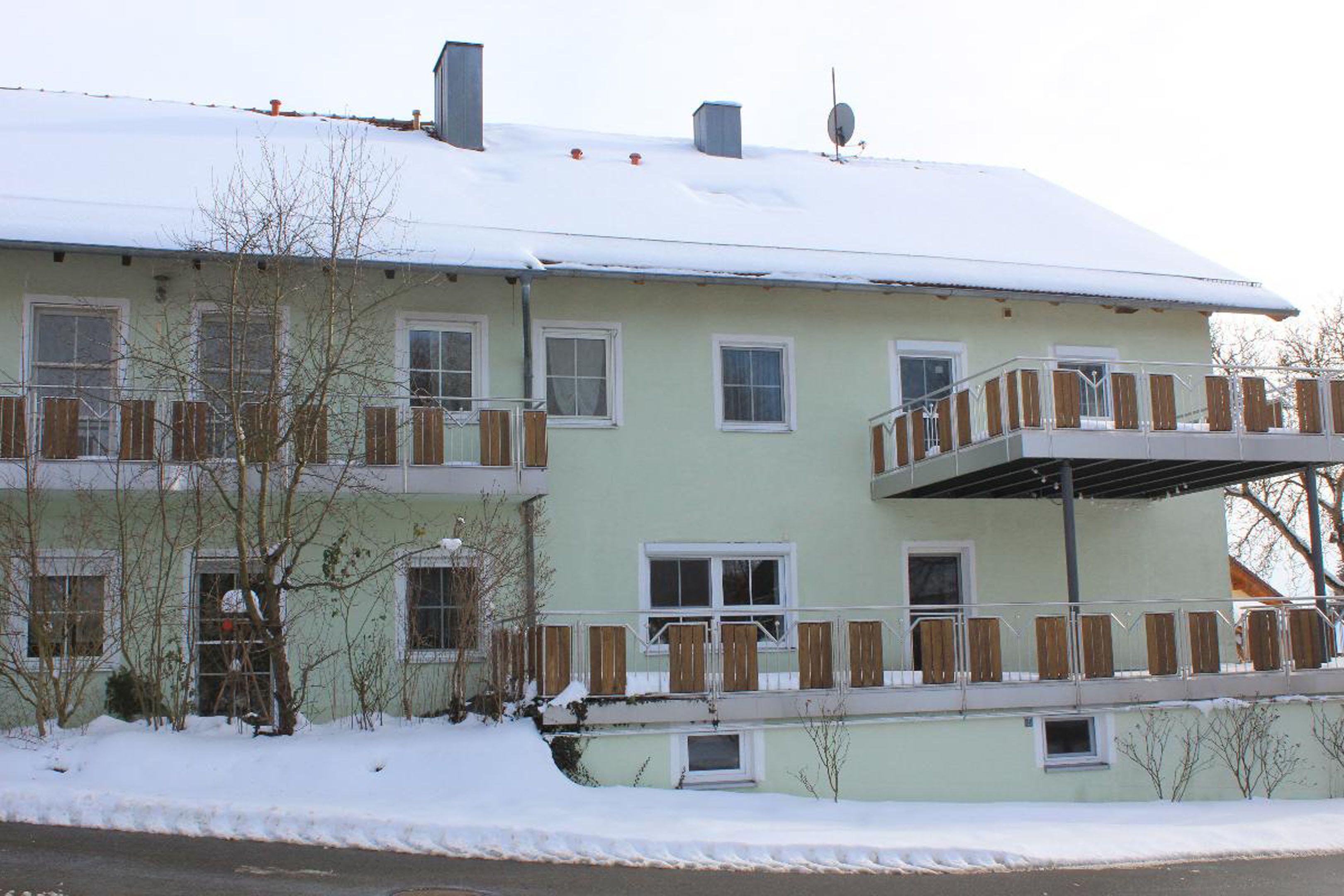 A two-story building with a balcony on the upper floor.