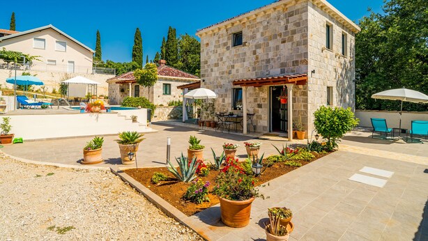 A stone building with a pool, outdoor seating, and potted plants. - Dubrovnik Chalets - 2 Charming Stone Houses (Konavle)