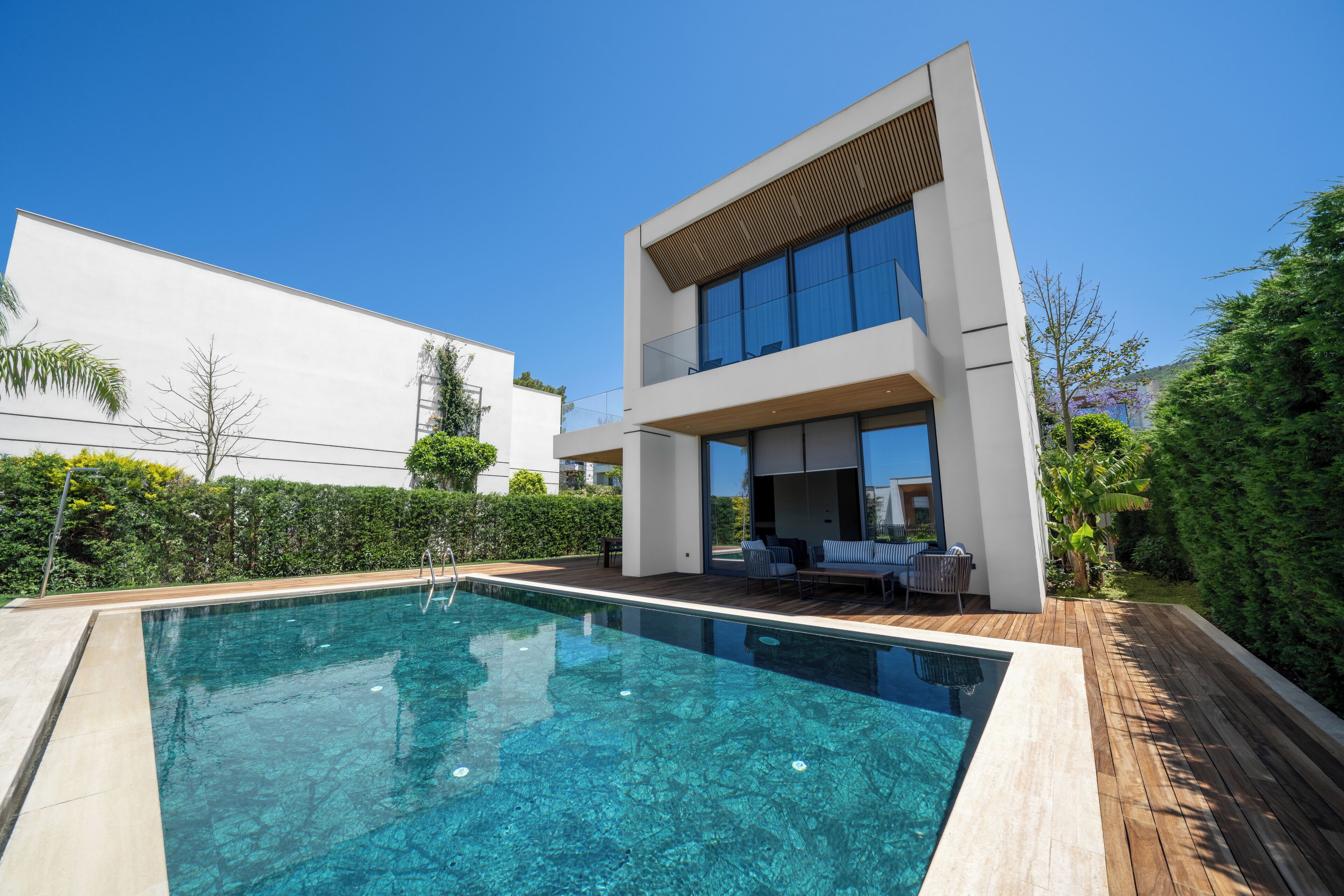 A modern two-story house with a swimming pool.