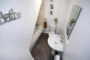 Bathtub, towels, toilet paper