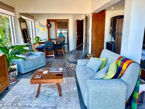 Relax in this inviting living room with a sofa, coffee table, and potted plant.