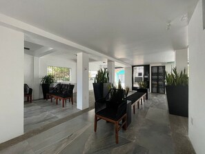Relax in a spacious lobby with comfortable seating areas and large windows.