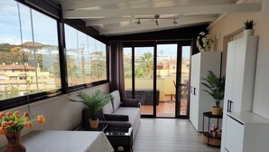 A modern kitchen with a dining area, large windows, and a view of the city. - Center La Cala De Mijas, penthouse,terrace 100 m², near beach and town center (LA CALA DE MIJAS)
