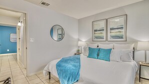 A bedroom with a large bed, a round mirror, and two framed artworks on the wall. - ✨ BY FORT BLISS: 2 KING BEDS, FAST WIFI, FULL BATH, LAUNDRY (El Paso)
