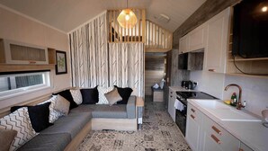 A modern kitchen with white cabinets, a built-in oven, and a large window. - 2 Bed Lodge - Sleeps 4 - Parking - Wifi (Inverness)