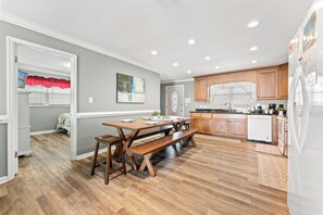 A modern kitchen with wooden cabinets, a built-in oven, and a refrigerator.