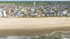 A coastal residential area with houses, a water tower, and a beach. - Summer Fun - Beach Across the Street (North Myrtle Beach)