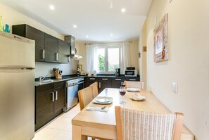 Enjoy meals in this well-equipped kitchen with a dining table for four, oven, and microwave.