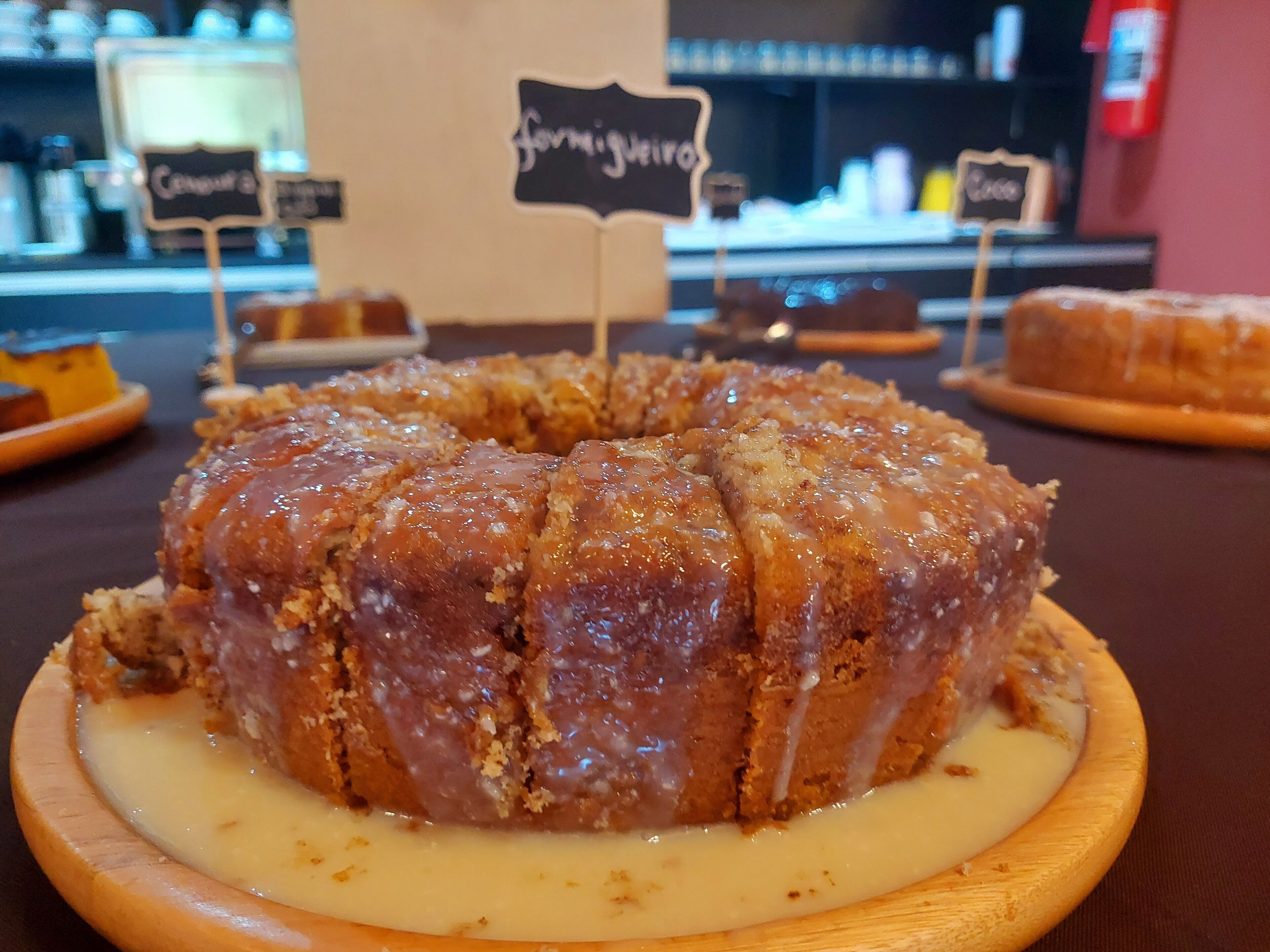 A bundt cake with a glaze on a wooden board.
