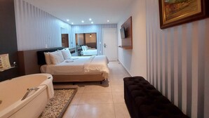 A hotel room with two beds, a large mirror, a TV mounted on the wall, and a painting. - Hotel Vila Suíça 1818 (Nova Friburgo)