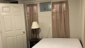 A room with a bed, a desk, a lamp, and curtains. - Dock Life Cottage 8 - Riverside, 1 Bedroom, Wasaga (Wasaga Beach)