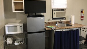 A compact kitchen with a refrigerator, microwave, and a small sink. - Dock Life Cottage 8 - Riverside, 1 Bedroom, Wasaga (Wasaga Beach)
