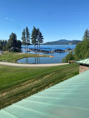 A lakeside view with a dock, boats, and a small building. - Best spot on the Lake, Water Front, View of the floating Green Golf Coarse (Harrison)
