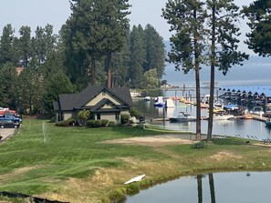 A lakeside property with a house, dock, and boats. - Best spot on the Lake, Water Front, View of the floating Green Golf Coarse (Harrison)