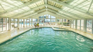 An indoor swimming pool with a high ceiling and large windows. - Breathtaking Panoramic Views of the Gulf (Pensacola)