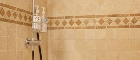 A shower with a handheld showerhead and a handheld hose.