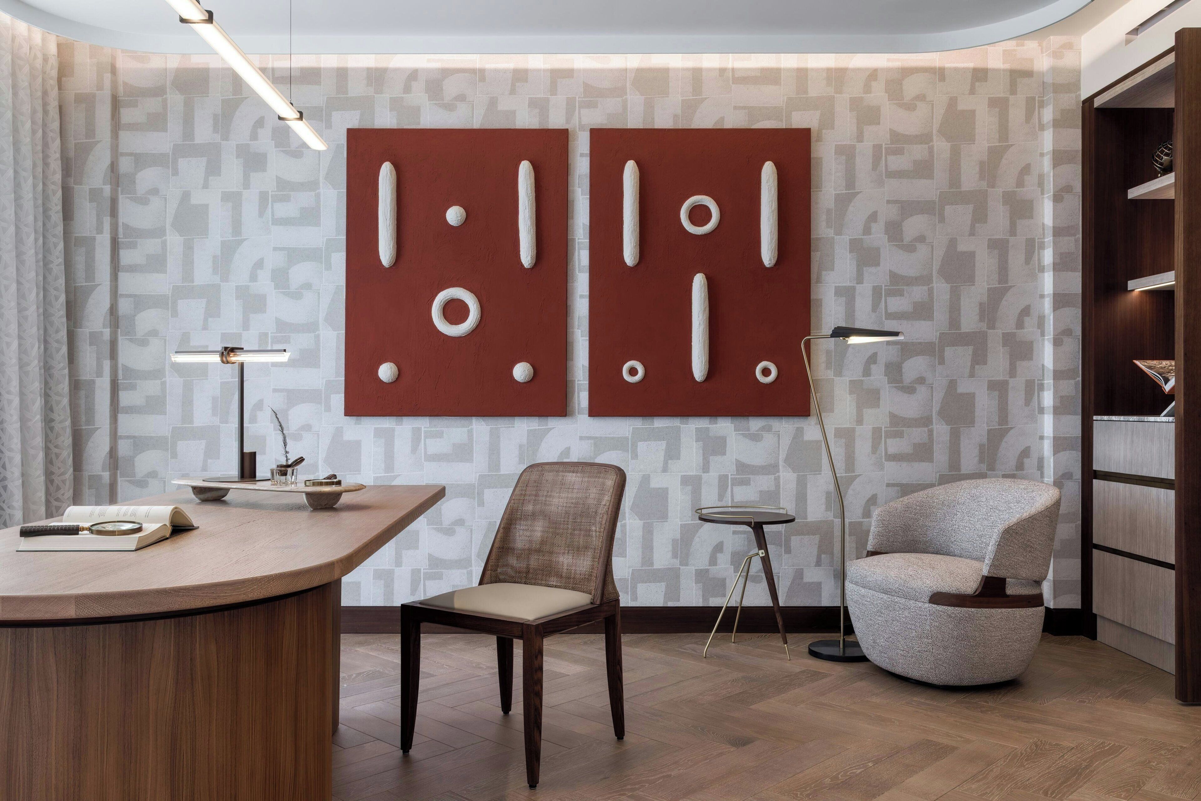 A modern room with a curved wooden desk, a round chair, a tall floor lamp, and a bookshelf.