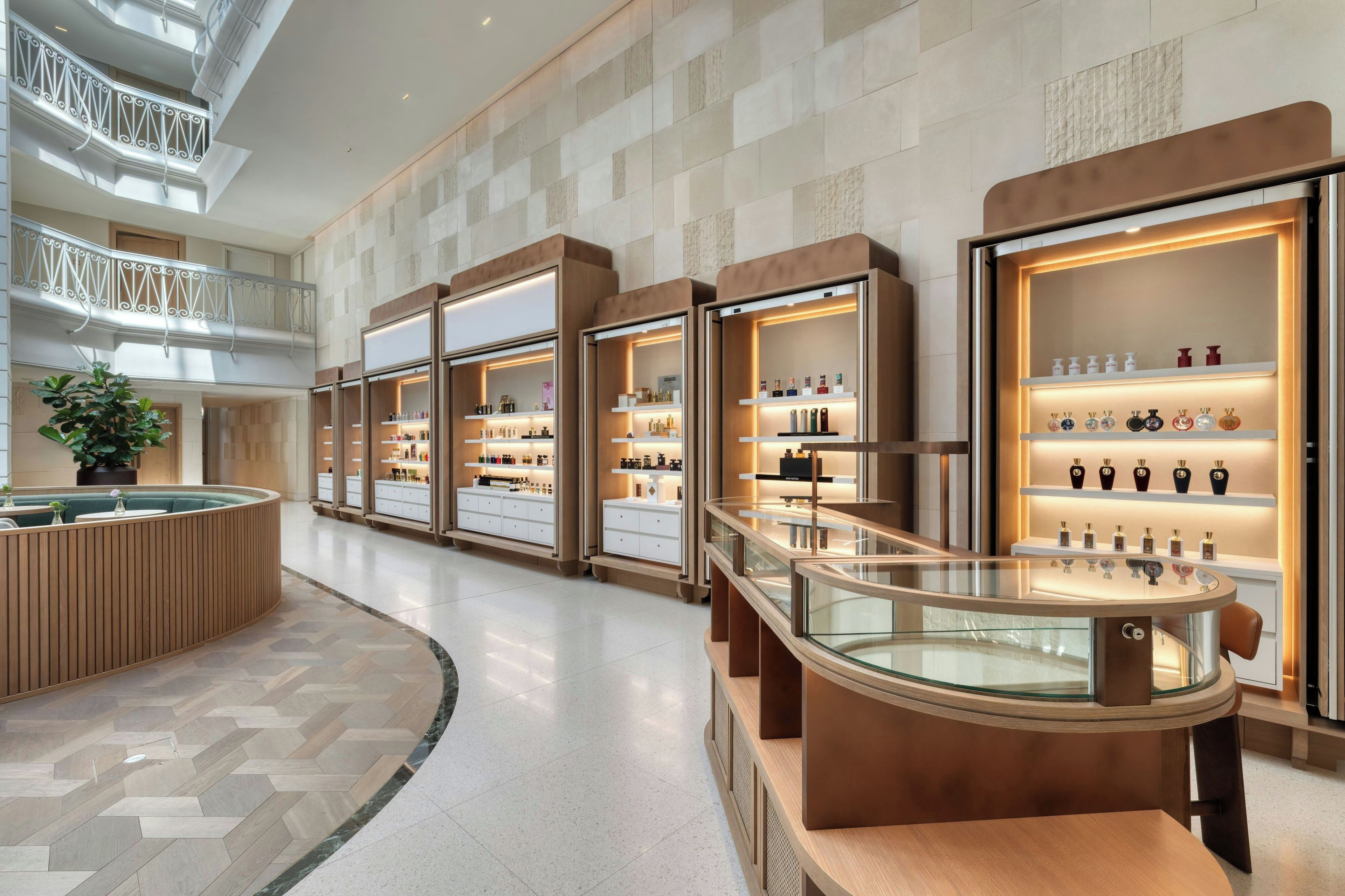 A modern retail space with glass display cases and a central seating area.