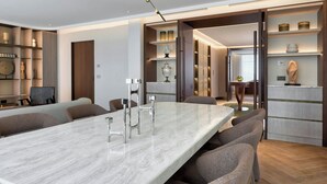 A modern dining area with a marble table, chairs, and a pendant light. - The Landmark Nicosia, Autograph Collection (Nicosia)