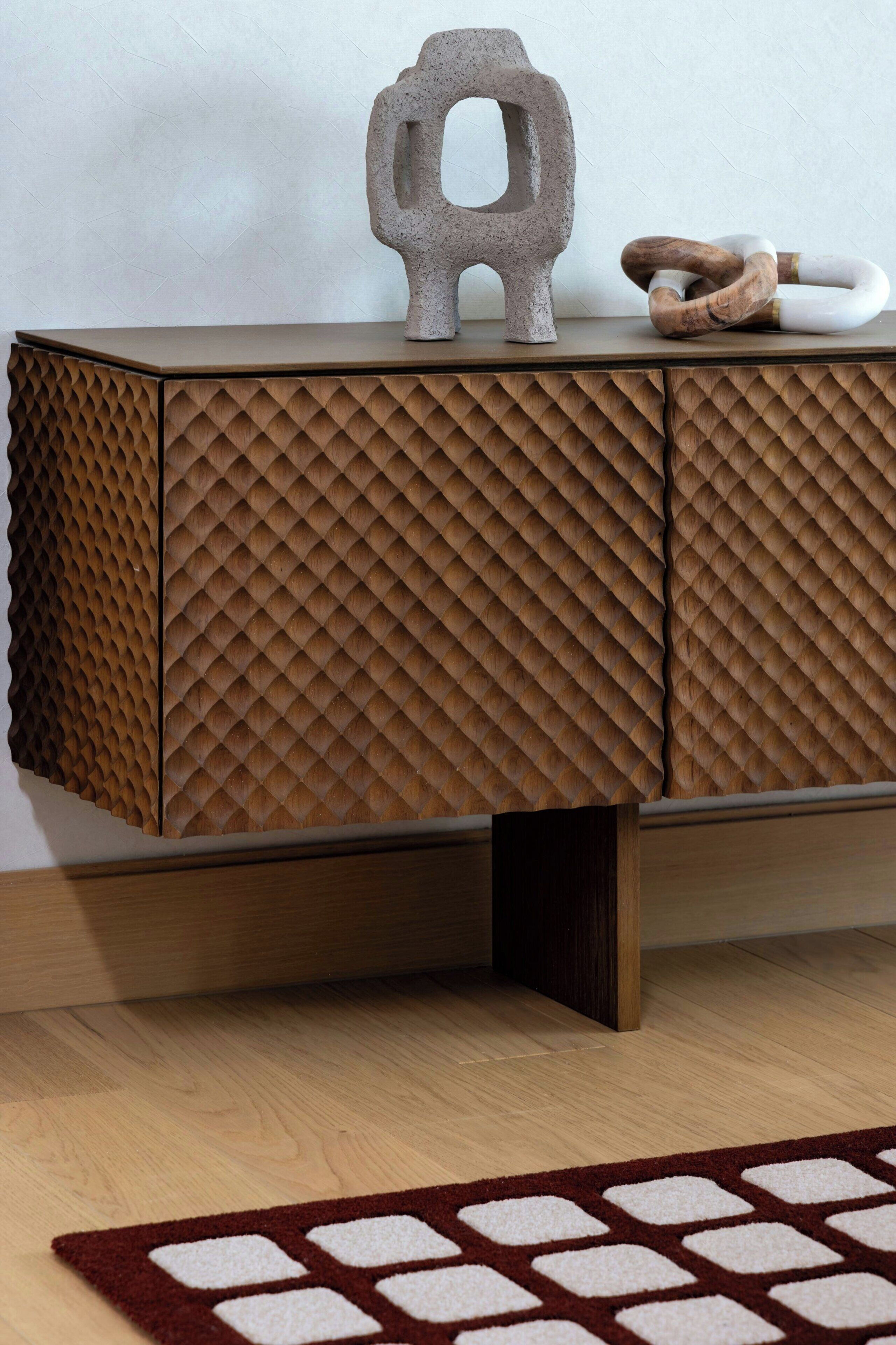 A wooden cabinet with a textured surface and a geometric cut-out design.
