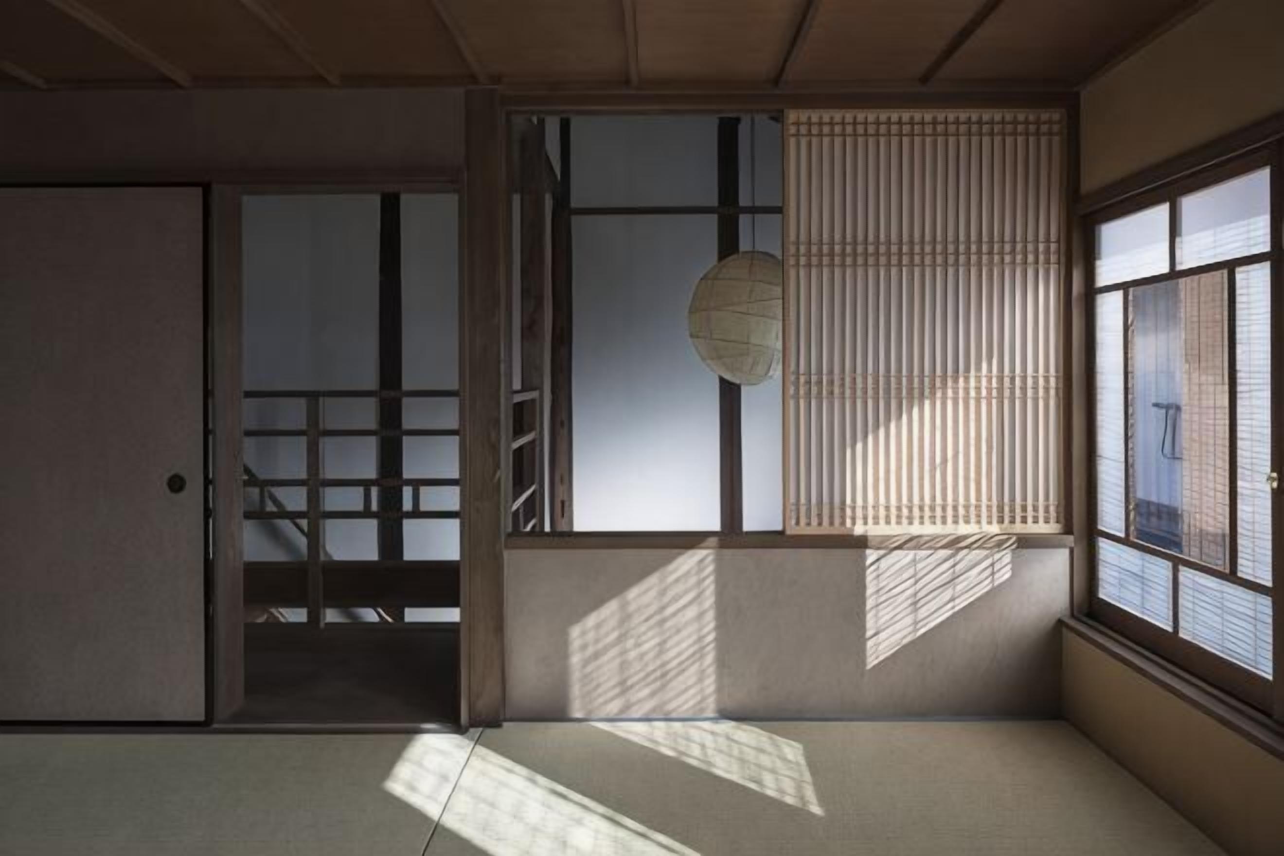 A traditional Japanese room with tatami flooring, sliding doors, and a shoji screen.
