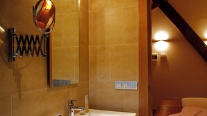 A modern bathroom with a large sink, mirror, and towel rack. - Hotel Altair (Santiago de Compostela)