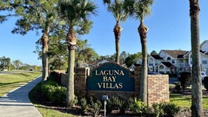 A sign for Laguna Bay Villas with a brick base and a blue background. - Fully Remodeled  stylish 3/2 condo, close to the parks (kissimmee)