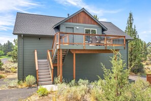 A two-story house with a wooden deck and a staircase leading to a balcony. - Dara 30 Day - Modern Irish Guest House on Private Estate, Mountain Views (Bend)