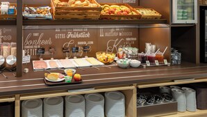 A breakfast buffet with various food items and condiments. - B&B Hotel Frankfurt-hahn Airport (Lautzenhausen)