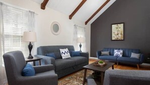 A living room with two sofas, a coffee table, and a lamp. - Pet Friendly & Fast WiFi - Fresh at Forest Hills (Montgomery)