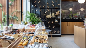 A buffet with various food items and a modern interior design. - Sapphire Blue Suites (Kissamos)