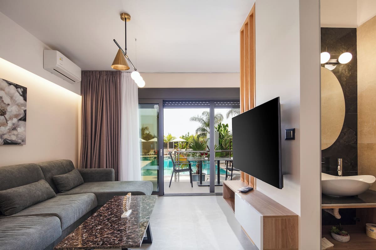Superior Two Bedroom Suite with Pool View | Living area | 32-inch Smart TV with cable channels, TV