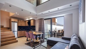 A modern living space with a staircase, dining area, kitchen, and a balcony with a view. - Sapphire Horizon Suites (Kissamos)