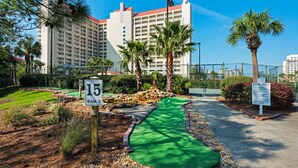 A miniature golf course with a green putting green, a 15-par 2 hole, and a sign indicating the hole number. - Tides 405 ~ Amazing gulf-front view ~ Huge private balcony (Miramar Beach)