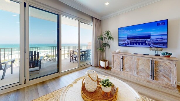 A hotel room with a balcony, a TV, a plant, and a decorative tray. - Tides 405 ~ Amazing gulf-front view ~ Huge private balcony (Miramar Beach)