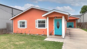 A single-story house with a red exterior and a blue door.